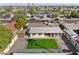 Backyard aerial view, including manicured lawn, brick patio, and privacy fence at 2525 E Nisbet Rd, Phoenix, AZ 85032