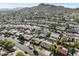 Aerial view of neighborhood showcasing houses, streets, and mountain backdrop at 2525 E Nisbet Rd, Phoenix, AZ 85032