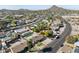 Overhead view of residential area with manicured lawns, desert landscaping, and mountain views at 2525 E Nisbet Rd, Phoenix, AZ 85032