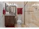 Stylish bathroom featuring a glass enclosed shower, granite countertop, and warm lighting at 2525 E Nisbet Rd, Phoenix, AZ 85032