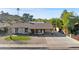 Charming single-story home with gravel landscaping, desert flora, and a spacious driveway at 2525 E Nisbet Rd, Phoenix, AZ 85032