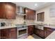 Modern kitchen featuring stainless steel appliances, granite countertops, and tile backsplash at 2525 E Nisbet Rd, Phoenix, AZ 85032