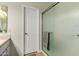 Bathroom featuring glass-enclosed shower and a white door at 26681 S Howard Dr, Sun Lakes, AZ 85248