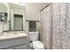 Bright bathroom features a granite-topped vanity and a decorative shower curtain at 26681 S Howard Dr, Sun Lakes, AZ 85248