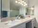 Bathroom featuring a double sink vanity, large mirror, and a glass-enclosed shower at 26681 S Howard Dr, Sun Lakes, AZ 85248