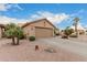 Exterior view of a single story home showcasing the two car garage and desert landscaping at 26681 S Howard Dr, Sun Lakes, AZ 85248