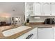 Close up of a kitchen sink with white cabinets and stainless steel appliances at 26681 S Howard Dr, Sun Lakes, AZ 85248