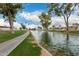 Scenic view of a calm waterway with lush landscaping and blue skies at 26681 S Howard Dr, Sun Lakes, AZ 85248