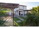 Beautiful backyard with a covered patio, pergola, and lush landscaping at 27 N 199Th Ave, Buckeye, AZ 85326