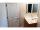 This bathroom features a modern vanity, neutral paint, and wood-look flooring at 27 N 199Th Ave, Buckeye, AZ 85326