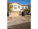 Two-story home features an attached two car garage, neutral color palette, and manicured front yard at 27 N 199Th Ave, Buckeye, AZ 85326