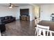 Spacious living room with wood-look tile flooring, ceiling fan, and plenty of natural light at 27 N 199Th Ave, Buckeye, AZ 85326