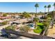 An attractive aerial view of a backyard pool, green lawn, and desert landscaping at 301 E Carol Ann Way, Phoenix, AZ 85022