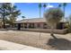 Charming single-story home featuring a tile roof, desert landscaping, and a neutral-tone facade at 301 E Carol Ann Way, Phoenix, AZ 85022