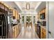 Bright kitchen with light wood cabinets, black appliances, and a dining area with backyard view at 301 E Carol Ann Way, Phoenix, AZ 85022