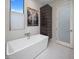 Bright bathroom with a modern freestanding tub, sleek fixtures, and a decorative art piece at 3106 N 70Th St # 2003, Scottsdale, AZ 85251