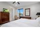 Bright bedroom featuring a ceiling fan, dresser, and a sliding glass door to a balcony with great views at 3106 N 70Th St # 2003, Scottsdale, AZ 85251