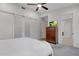 Bright bedroom featuring a ceiling fan, dresser, a TV, and an ensuite bathroom at 3106 N 70Th St # 2003, Scottsdale, AZ 85251