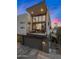 Contemporary home featuring a balcony and a ground-level garage, set against a vibrant sunset sky at 3106 N 70Th St # 2003, Scottsdale, AZ 85251