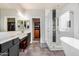 Modern bathroom featuring double sink vanity, glass enclosed shower, and soaking tub at 3194 E Mead Dr, Chandler, AZ 85249