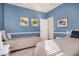 Stylish blue bedroom featuring two twin beds, white trim, and ample wall art at 3194 E Mead Dr, Chandler, AZ 85249