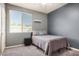 Comfortable gray bedroom featuring natural light, neutral walls, and soft carpet at 3194 E Mead Dr, Chandler, AZ 85249