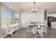 Dining nook with white chairs, natural light, and adjacent to the kitchen at 3194 E Mead Dr, Chandler, AZ 85249