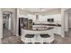 Modern kitchen with white cabinets, stainless steel appliances, and a peninsula with bar seating at 3194 E Mead Dr, Chandler, AZ 85249