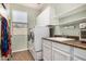 Functional laundry room with a washer and dryer, sink, and built-in shelves for storage at 3194 E Mead Dr, Chandler, AZ 85249