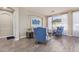 Bright living room with blue chairs, wood floors, and natural light from the large windows at 3194 E Mead Dr, Chandler, AZ 85249