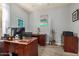 Functional home office featuring wood desk, shelving, neutral walls, and ample natural light at 3194 E Mead Dr, Chandler, AZ 85249