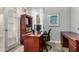 Functional home office featuring wood desk, shelving, neutral walls, and ample natural light at 3194 E Mead Dr, Chandler, AZ 85249