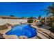 Private backyard oasis features a sparkling pool with mature landscaping and rock waterfall at 3194 E Mead Dr, Chandler, AZ 85249