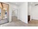 Bright entryway featuring neutral tile flooring, and an open view into a carpeted room, offering a welcoming transition at 37582 W San Clemente St, Maricopa, AZ 85138