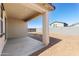 Covered patio with a concrete slab, stucco walls, and a view of the backyard with block fencing at 37582 W San Clemente St, Maricopa, AZ 85138