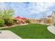 Spacious backyard with lush green grass, seating, and landscaping, great for outdoor activities at 3932 E Torrey Pines Ln, Chandler, AZ 85249