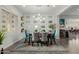 Bright dining room with a decorative accent wall, stylish light fixture, and a colorful geometric rug at 3932 E Torrey Pines Ln, Chandler, AZ 85249