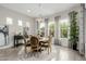 Elegant dining area with a round table, decorative chandelier, and large windows providing natural light at 3932 E Torrey Pines Ln, Chandler, AZ 85249