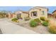 Beautiful desert landscaping with rocks and native plants enhance the curb appeal of this home at 3932 E Torrey Pines Ln, Chandler, AZ 85249