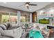 Spacious living room featuring a large sectional sofa, media center, and sliding glass doors to the backyard at 3932 E Torrey Pines Ln, Chandler, AZ 85249