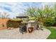 Outdoor bar area with grill, seating, and lush landscaping, perfect for entertaining at 3932 E Torrey Pines Ln, Chandler, AZ 85249