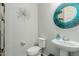 Stylish powder room with a decorative mirror and pedestal sink at 3932 E Torrey Pines Ln, Chandler, AZ 85249