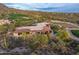 Stunning aerial view of estate home with tile roof, pool and desert landscaping adjacent to a golf course at 41731 N Stone Cutter Dr, Scottsdale, AZ 85262