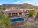 Beautiful home with a pool, native landscaping, and stone accents, seamlessly blending luxury with the natural environment at 41731 N Stone Cutter Dr, Scottsdale, AZ 85262