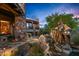 Stunning backyard featuring stone accents, native vegetation, and an impressive sculpture, all harmonizing with the natural desert setting at 41731 N Stone Cutter Dr, Scottsdale, AZ 85262