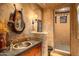 Unique bathroom featuring copper sink, stone countertop, and rustic decor at 41731 N Stone Cutter Dr, Scottsdale, AZ 85262