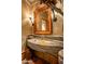 Unique bathroom featuring a stone sink, textured walls, and rustic accents, creating a warm and inviting atmosphere at 41731 N Stone Cutter Dr, Scottsdale, AZ 85262