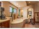 This inviting bathroom features a soaking tub, cactus decor, and natural light at 41731 N Stone Cutter Dr, Scottsdale, AZ 85262