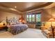 Bedroom featuring desert views, a wrought-iron bed frame, and a seating area at 41731 N Stone Cutter Dr, Scottsdale, AZ 85262