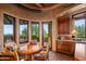 Cozy breakfast nook with bright windows, custom cabinets and a view of the outdoor patio at 41731 N Stone Cutter Dr, Scottsdale, AZ 85262